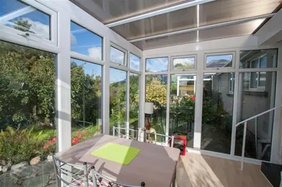 a screened in porch with a table and chairs at Brimbles in Keswick