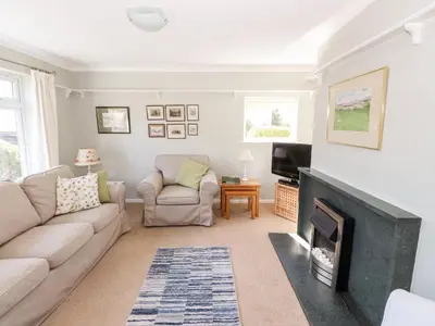 a living room with a couch and a fireplace at Brimbles in Keswick