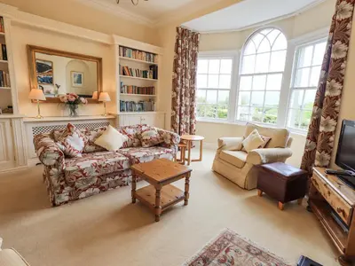 a living room with a couch and a table at Grisedale View in Keswick