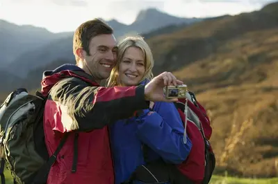 a man and a woman taking a picture with a camera at Mellbreak in Chapel Stile