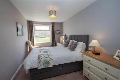 a bedroom with a bed and a dresser and a window at Mellbreak in Chapel Stile