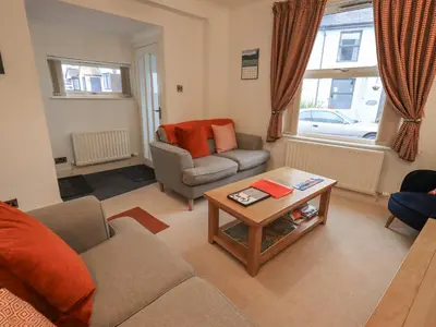 a living room with a couch and a table at Holme Rigg in Keswick
