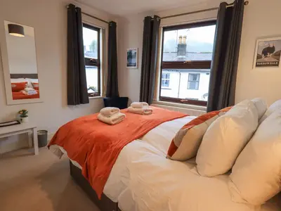 a bedroom with a bed with two towels on it at Holme Rigg in Keswick