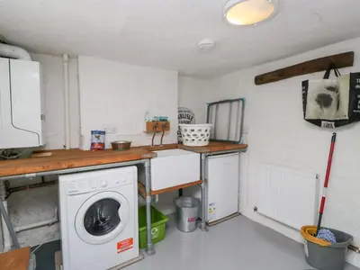 a laundry room with a washing machine in it at Latch Cottage in Keswick