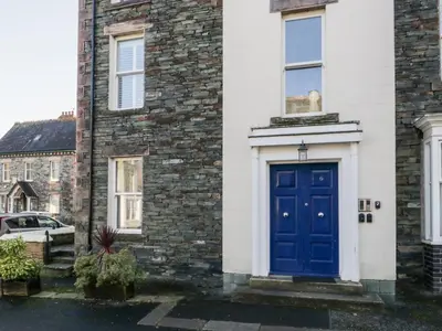 a blue door on the side of a house at Carlton House Apartment 1 in Keswick