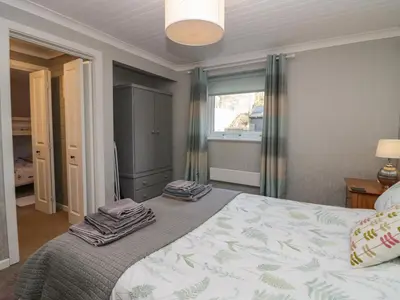 a bedroom with a bed with towels on it at The Chalet in Egremont