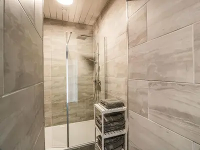 a bathroom with a shower with a glass door at Rothiemay in Girvan