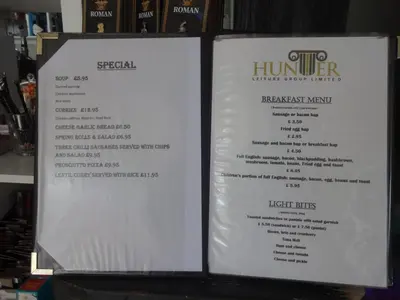 a menu for a restaurant with two white signs at Bowness Bed & Breakfast Double Room, Bowness-on-Solway in Bowness-on-Solway