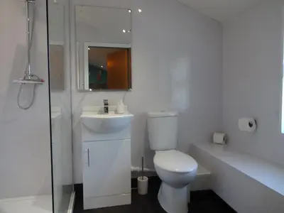 a white bathroom with a toilet and a sink at John Collingwood, Bowness-on-Solway ideal for starting of finishing a walk along Hadrians Wall in Bowness-on-Solway