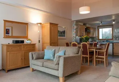 a living room with a couch and a dining room at Keswick Bridge 13, within walking distance of Keswick town centre, strictly no pets in Keswick