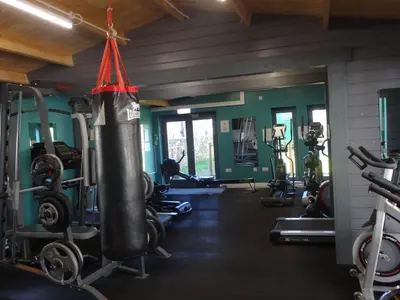 a gym with a punching bag hanging from the ceiling at Ryans Retreat, Bowness on Solway perfect for a break when walking Hadrians Wall with a hot tub in Bowness-on-Solway