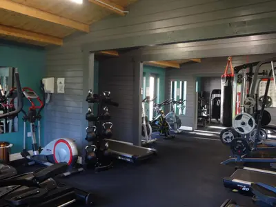 a gym with several treadmills and bikes in it at Ryans Retreat, Bowness on Solway perfect for a break when walking Hadrians Wall with a hot tub in Bowness-on-Solway