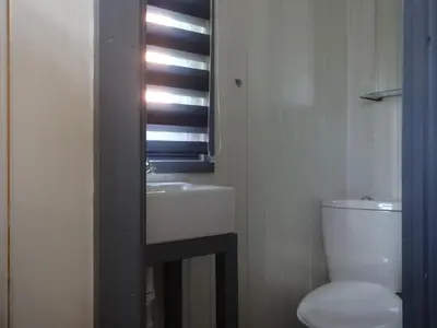a bathroom with a sink and a toilet and a window at Sians Retreat, Bowness on Solway, perfect stop over when walking Hadrians Wall with hot tub in Bowness-on-Solway