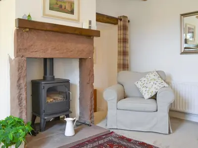 a living room with a fireplace with a couch and a stove at The Retreat in Sunderland