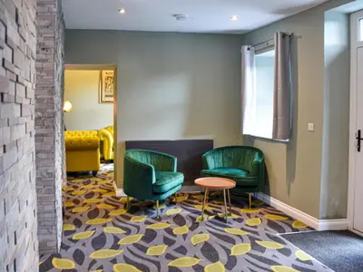 a waiting room with two chairs and a table at Ivy House in Dockray