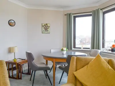 a living room with a table and chairs at Harbour Watch in Maryport
