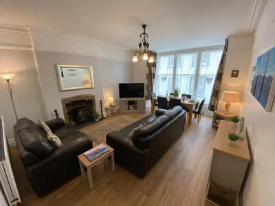 a living room with leather couches and a fireplace at Ridge View - Amazing Roof Terrace in Keswick