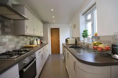 a kitchen with a sink and a counter top at Luxury House Near City Center Hospital &Superstore in Carlisle