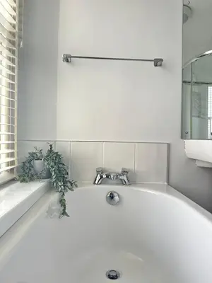a white bath tub with a faucet in a bathroom at 1 The Croft in Cockermouth