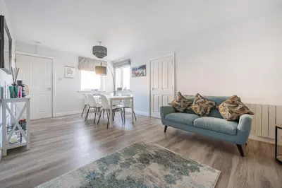 a living room with a couch and a table at Normsy Place Seaside Serenity Breath Taking Views in St Bees