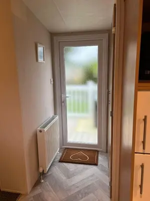 a hallway with a door leading to a patio at Turnberry Holiday Home in Turnberry