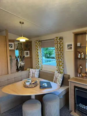 a living room with a table and a couch at Turnberry Holiday Home in Turnberry