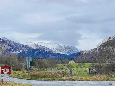 a sign on a road with mountains in the background at Teapot Cottage in Ennerdale - Hot tub Pizza Oven Log Burner in Cleator