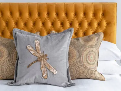 a pillow with a dragonfly on it sitting on a bed at Apartment 3 Helvellyn in Keswick