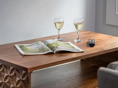 a wooden table with two glasses of white wine at Apartment 3 Helvellyn in Keswick