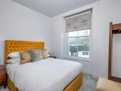 a bedroom with a large bed and a window at Apartment 4 Skiddaw in Keswick