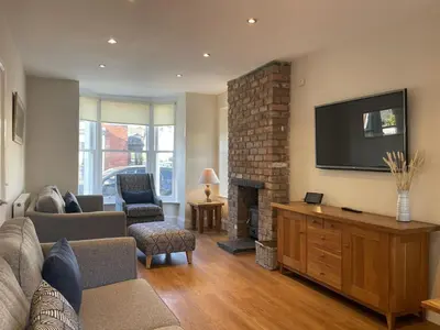 a living room with a couch and a fireplace at Wordsworth House HOT TUB HIRE AVAILABLE in Keswick