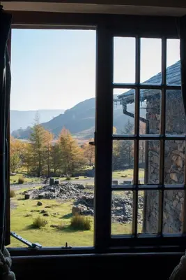 a window with a view of a mountain view at The Mountain Cottages - Sawyers in Coniston