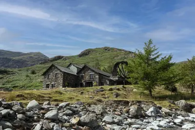 an old house on a hill in the mountains at The Mountain Cottages - Sawyers in Coniston