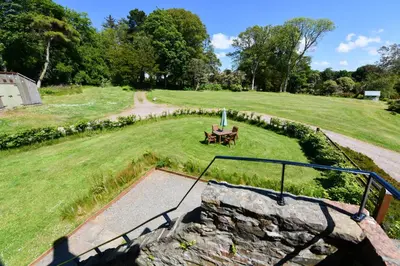an aerial view of a field with a table and a umbrella at Stables Cottage in Stranraer