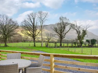 a table and chairs on a fence with a view of a field at Dodd - Uk42499 in Bassenthwaite