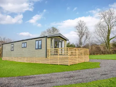 a tiny house with a wooden fence around it at Dodd - Uk42499 in Bassenthwaite