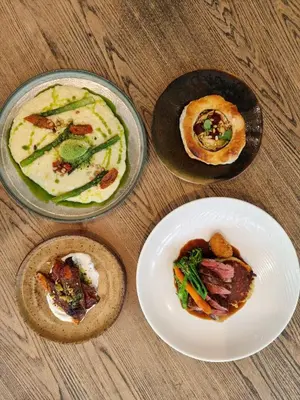 three plates of food on a wooden table at The Old Mill Inn in Dearham