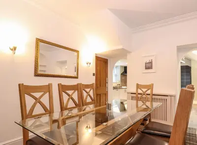 a dining room with a glass table and chairs at Blencathra in Keswick