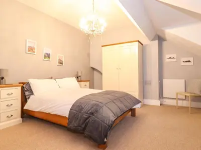 a bedroom with a bed and a chandelier at Blencathra in Keswick