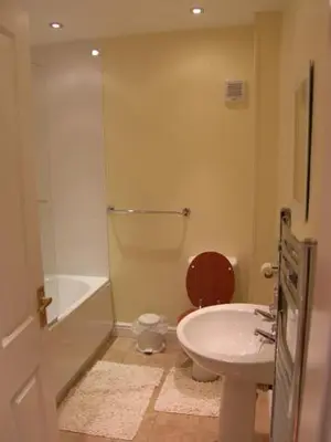 a bathroom with a toilet and a sink at Pinfold Holiday Cottage in Laxey