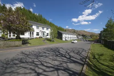 a street in a small town with white houses at Herdwick Place Langdale Valley in Great Langdale