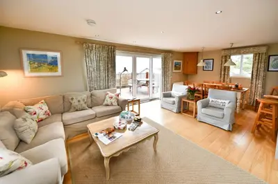 a living room with a couch and a table at Cedar Lodge in Portpatrick