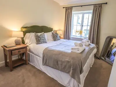 a bedroom with a bed with towels on it at St Giles in Ambleside
