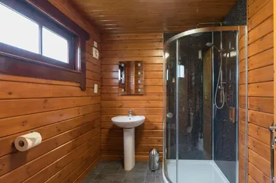 a bathroom with a sink and a shower at Lady Galloway 29 with Hot Tub in Newton Stewart