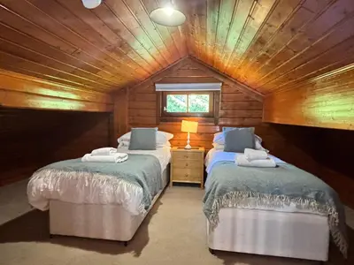 two beds in a room with a attic at Lady Galloway 30 with Hot Tub in Newton Stewart