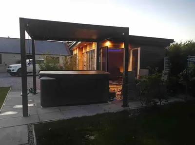 a house with a large backyard with a gazebo at Amazing Cottage & detached Annex sleeps 8, Extra Deep Hot tub, Super Fast wifi, New for 2024 is the addition of Wood Fired Sauna in Castle Douglas