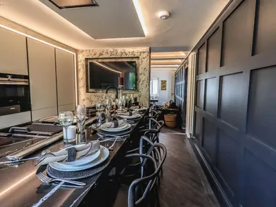 a long dining room with a long table with chairs at Whisk Away Cottage in Penrith