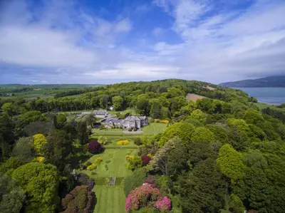 an aerial view of a large house in the trees at Home Farm Cottage in Stranraer