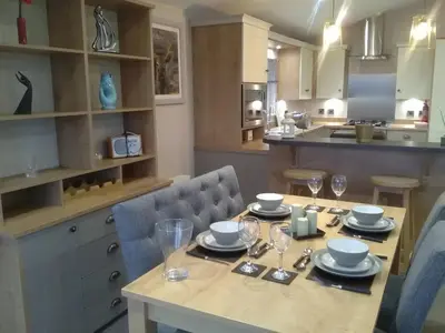 a kitchen with a table with glasses on it at Turnberry lodge in Girvan