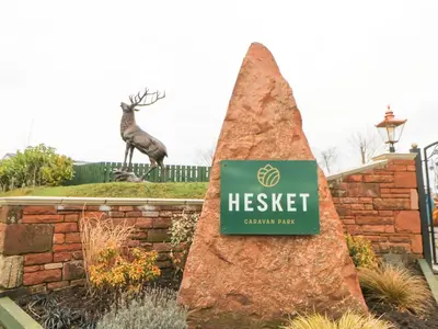 a sign for heisel garden park with a deer statue in the background at Rosie's Zen Den in Carlisle